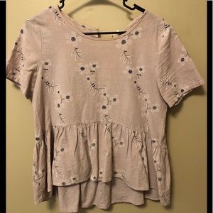 Pink blouse with flowers.